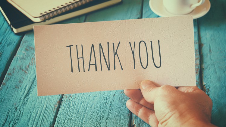 Man holding thank you note after fundraiser