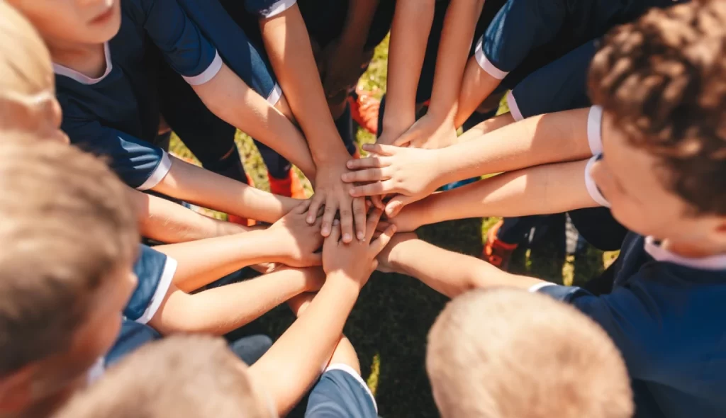 Sports team putting their hands together