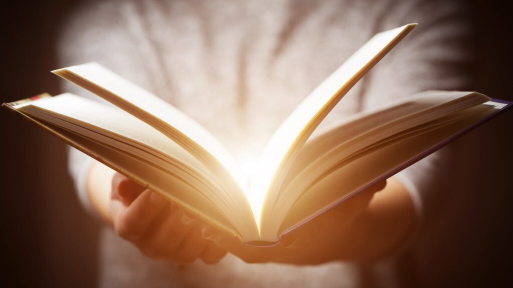 Woman opening glowing book