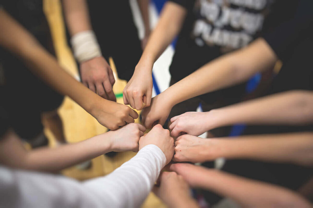 Fist bumping students after fundraising event